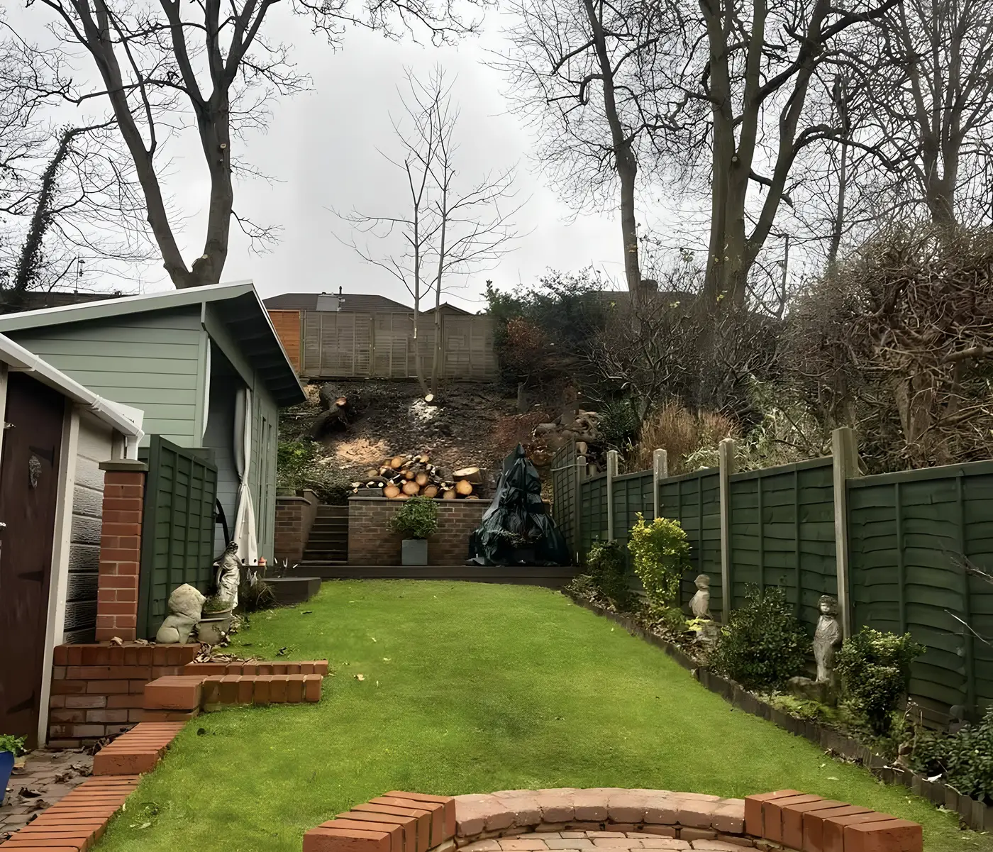 Rear garden we rebuilt in Millbrook: curved brick retaining wall, steps and a new lawn