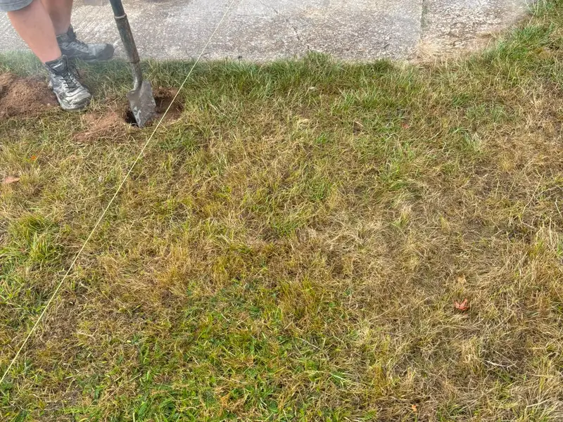 Setting out a new edge with a string line across the lawn before breaking ground
