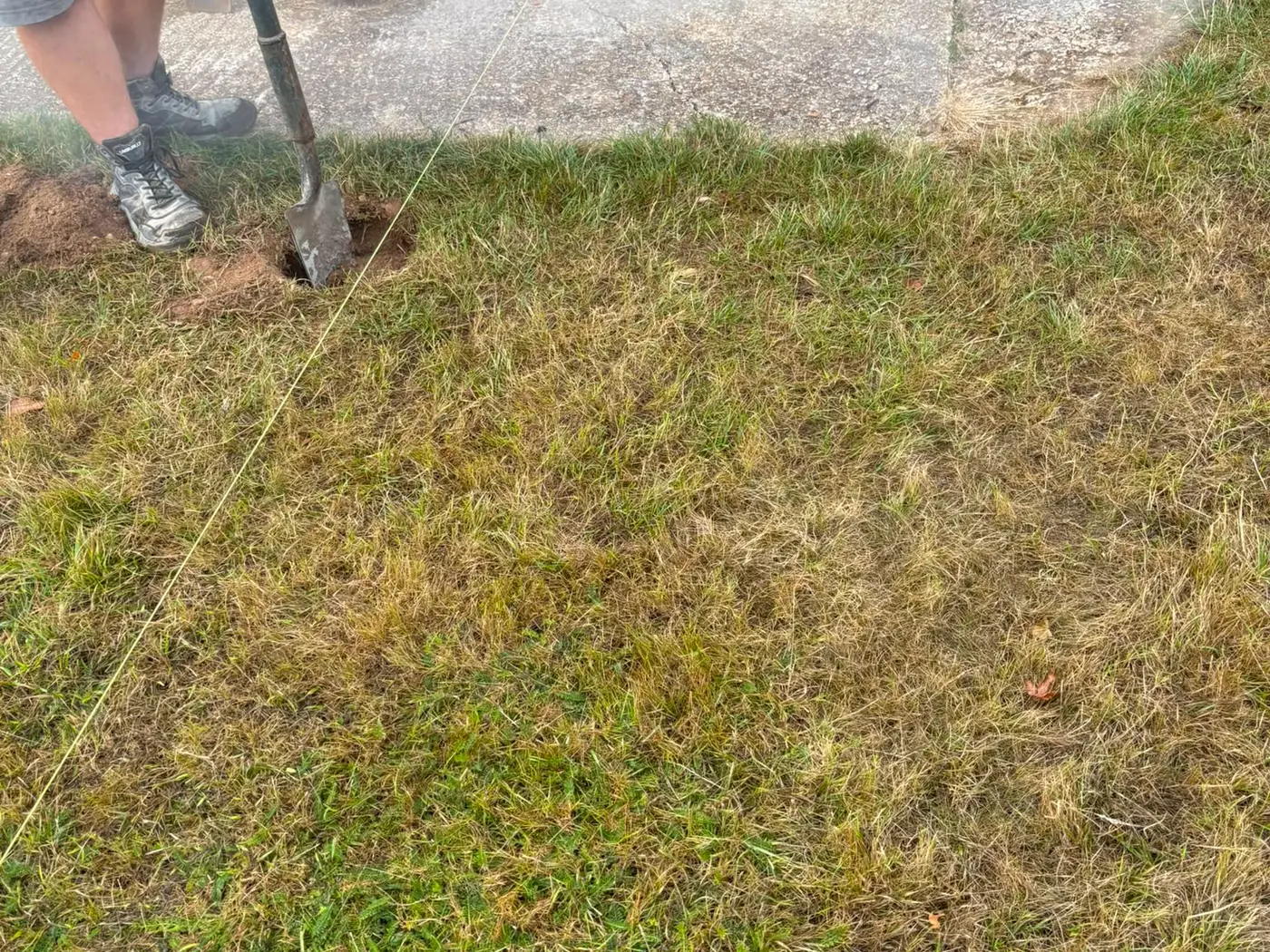 Setting out a new edge with a string line before breaking into the existing ground
